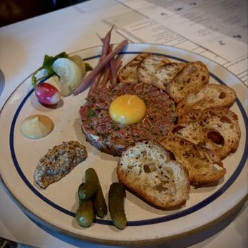 Angèle Restaurant and Bar signature dishes Escargo, Steak Tartare, French Onion Soup.